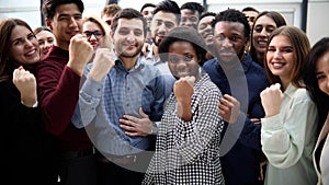 Confident diverse college students show fist up.