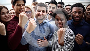 Confident diverse college students show fist up.