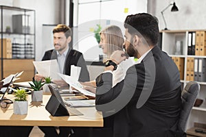 Confident diverse people discussing business plan at office