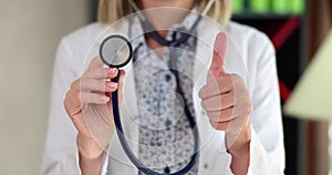 Confident doctor approvingly raises finger up