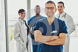 Confident doctor in front of group