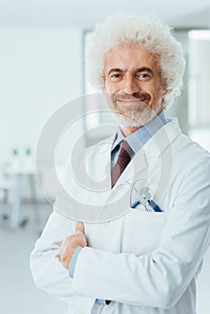 Confident doctor posing with folded arms