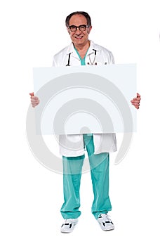Confident doctor showing blank whiteboard