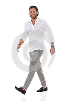 Confident Elegant Man Is Walking, Looking At Camera And Smiling