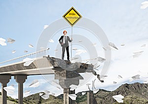 Confident engineer holding street safety sign.