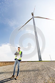 Confident Engineer Overseeing Renewable Energy Project at Wind Farm