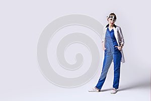 Confident ENT doctor wearing surgical headlight head light and protective glasses. Full length portrait of female