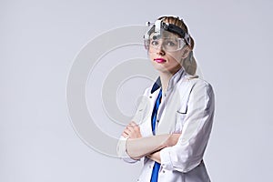 Confident ENT doctor wearing surgical headlight head light and protective glasses. Portrait of female otolaryngologist