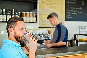 Confident entrepreneur choose drink in paper cup to go while communicate mobile. Save your time. Man speak mobile phone