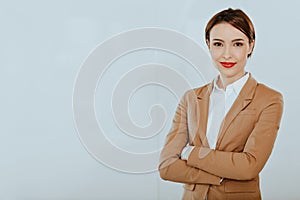 Confident entrepreneur woman smiling on light blue background