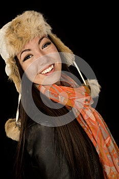 Confident ethnic teen wearing winter scarf and hat