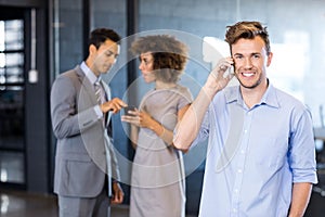 Confident executive talking on mobile phone