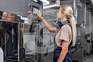 confident factory worker turn on the robotic line for pesticides bottling and packing