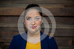 Confident female business executive standing in office