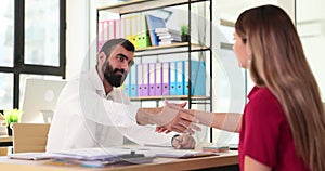 Confident female candidate undergoes interview, completes official appointment and shakes hands with company HR manager