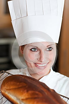 Confident female chef baking bread