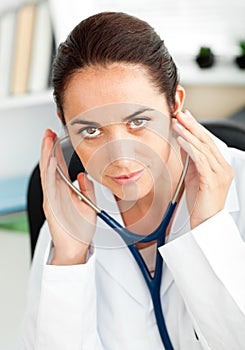 Confident female doctor holding a stethoscope