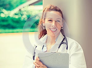 Confident female doctor medical professional standing outside