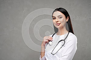 Confident female doctor smiling to camera in hospital.