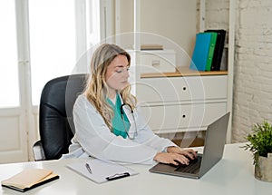 Confident female doctor working on medical consultation on laptop at hospital or clinic office