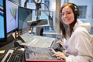 Confident Female Host Smiling In Radio Station