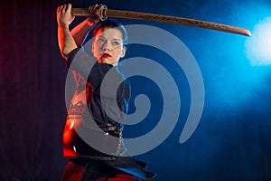 Confident female kendo fighter isolated