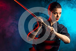 Confident female kendo warrior with shinai