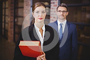 Confident female lawyer with businessman in office