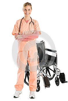 Confident Female Nurse Smiling While Standing By Wheelchair