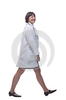 confident female paramedic striding forward. isolated on a white background.