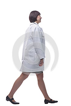 confident female paramedic striding forward. isolated on a white background.