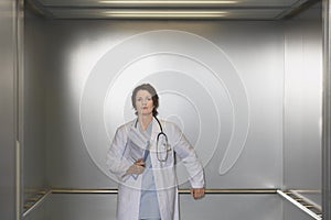 Confident Female Physician In Elevator