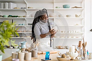 Confident female pottery artist in her art studio