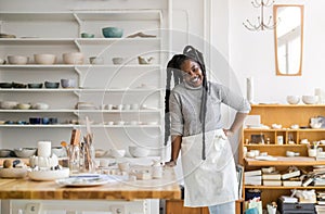 Confident female pottery artist in her art studio