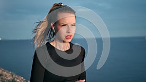 Confident female runner enjoy morning training at sunrise seascape slowmo. Medium shot on RED camera