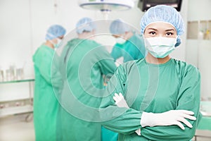 Confident female surgeons crossed hands with teams