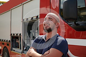 Confident firefighter stands with crossed arms, exuding resilience and preparedness, ready to respond to emergencies