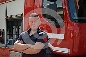 Confident firefighter stands with crossed arms, exuding resilience and preparedness, ready to respond to emergencies