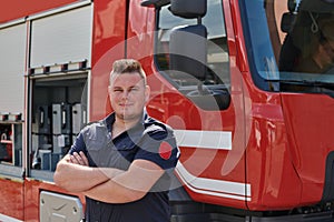 Confident firefighter stands with crossed arms, exuding resilience and preparedness, ready to respond to emergencies