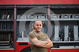 Confident firefighter stands with crossed arms, exuding resilience and preparedness, ready to respond to emergencies