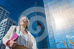 Confident, focused and powerful business woman walking in a modern office building. Young female corporate professional