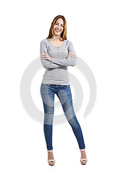 Confident full body of a casual happy woman standing wearing jeans photo