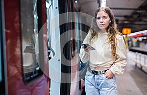 Portrait of a girl in the subway, about to enter the train car photo