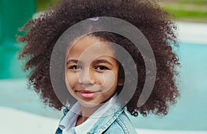 Confident girl with bright smile and beautiful curly hair