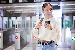 Confident girl entered the subway, passing through the turnstile