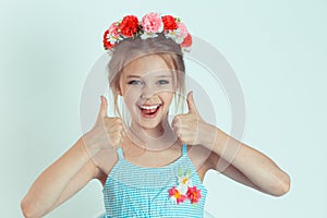 Confident girl showing thumbs up like sign gesture with hands
