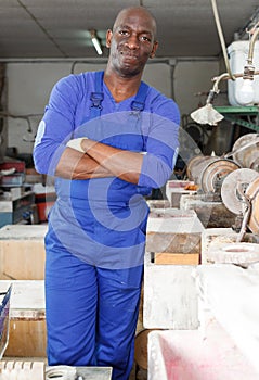 Confident glazier in glass workroom