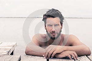 Confident Gorgeous Handsome Man with No Shirt at the Sea