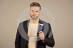Confident in hair care product. Man stylish hairstyle holds bottle hygienic product grey background. Switch matte