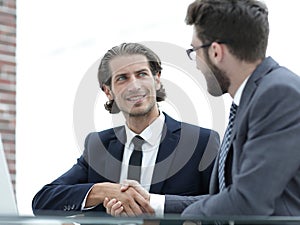 Confident handshake colleagues in the office